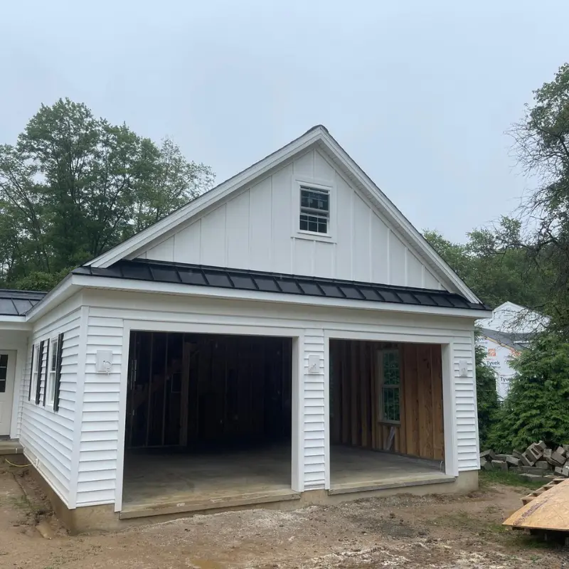 Finished two-car garage with board and batten siding and metal roof