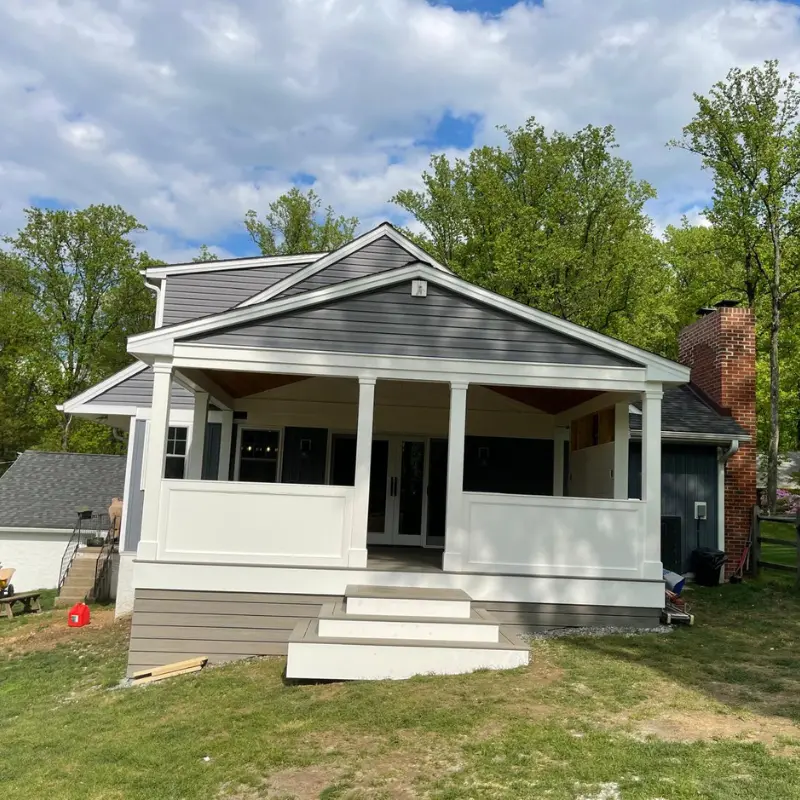 Finished covered porch with white columns and wood ceiling